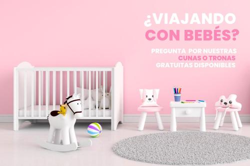 a pink room with a crib and other furniture at Balcón con Vistas I Cerca de Rutas de Senderismo in El Tarter