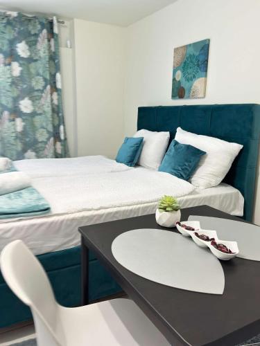 a room with two beds and a table and chairs at Apartman Safir 1 & Apartman Safir 2 & Apartman Safir 3 in Kruševac