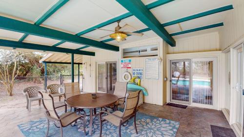 a dining room with a table and chairs at GREAT DUNES COTTAGE home in Jekyll Island