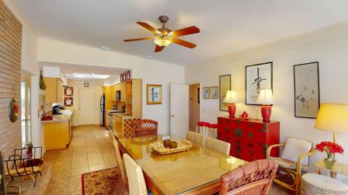 a living room with a ceiling fan and a table at GREAT DUNES COTTAGE home in Jekyll Island