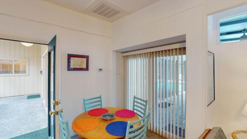 a dining room with a table and chairs at GREAT DUNES COTTAGE home in Jekyll Island