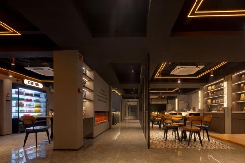 a restaurant with tables and chairs and a fireplace at Mcsrh Hotel-Changsha IFS and WUYI Plaza in Changsha