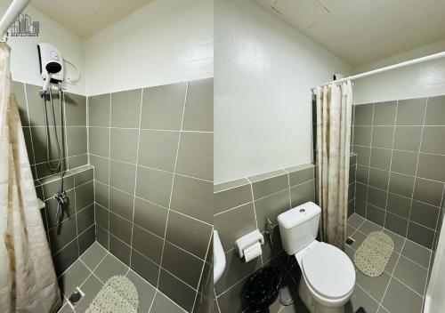 a bathroom with a toilet and a shower at 2-Bedroom Condo with FREE Gym, Pool & Parking Access in Puerto Princesa - B2 5Luster in Puerto Princesa City