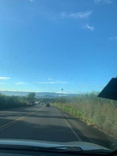 a view of a road with cars on it at Hospedaje Oropendola Nest in Bagaces