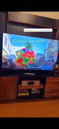 a flat screen tv sitting on top of a cabinet at Cabaña el bucanero in Pasto