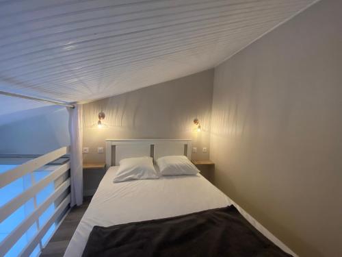 une chambre avec un lit blanc avec deux oreillers dans l'établissement Maisonnette rénovée proche plage, centre-ville, avec terrasse et parking privé - FR-1-22-175, à La Tranche-sur-Mer
