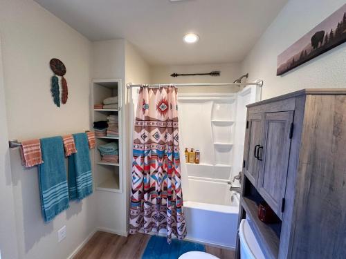 a bathroom with a shower with a shower curtain at Bandera Stronghold Retreat in Bandera