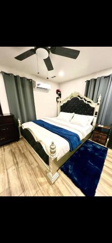 a bedroom with a bed and a ceiling fan at Furnished apartmt near down town with king bed in Dallas
