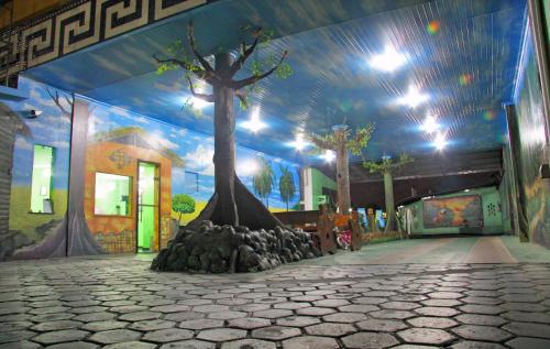 a mural of a tree on the wall of a building at Hotel Riviera D Amazonia Belem Ananindeua in Belém