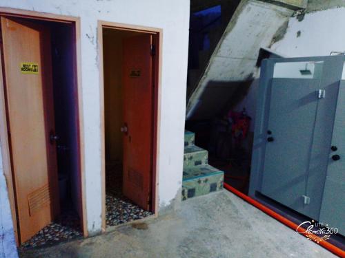 a hallway with two doors and a stair case at Angler's Hub & Resort Oslob in Oslob