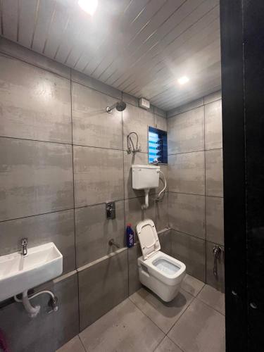 a bathroom with a toilet and a sink at Heritage Villa in Thane