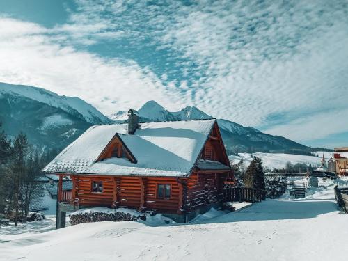 a log cabin with snow on the roof at Chatka u Bratka - Chalet, Stunning Mountain Views in Ždiar