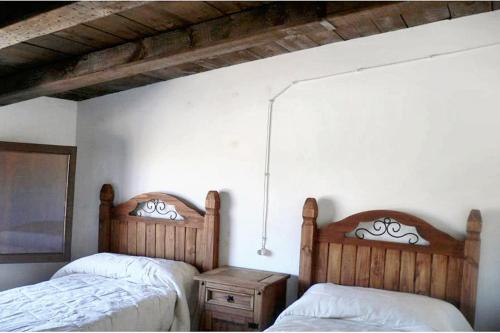 a bedroom with two beds and a night stand at Luxurious Villa in Loja with pool in Loja