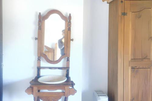 a mirror sitting on top of a wooden chair at Luxurious Villa in Loja with pool in Loja