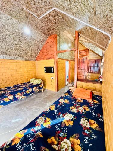 a large room with two beds in a room at Cozyo Stays Boutique Home Jowai in Jowai