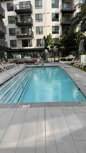 a large swimming pool in front of a building at Wallace Luxurious in Los Angeles