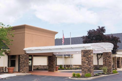 an office building with an american flag on top at Wyndham Garden Westlake in Westlake