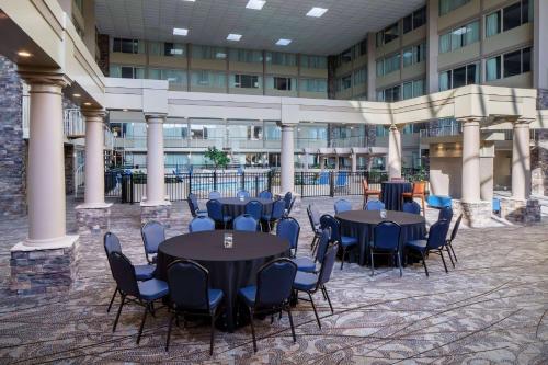 a courtyard with tables and chairs in a building at Wyndham Garden Westlake in Westlake