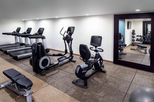 a fitness room with treadmills and elliptical machines at Wyndham Garden Westlake in Westlake