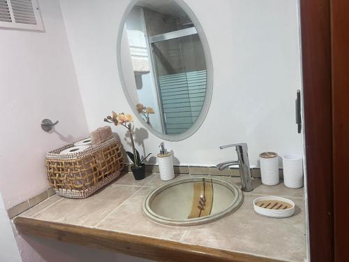 a bathroom sink with a mirror on a counter at Manolo IV,playa y relajacion in Tucacas
