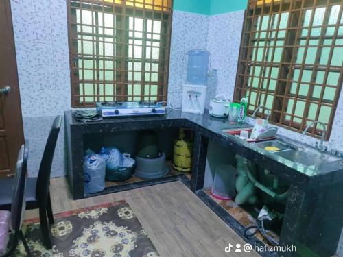 Kampong Kubang GolokTokMaa Inap Desa的带水槽和台面的厨房