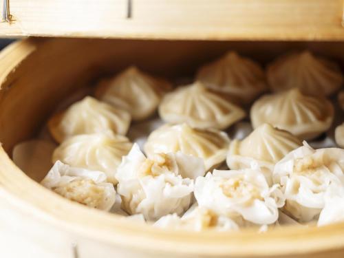 a bowl of dumplings in a wooden dish at Richmond Hotel Obihiro Ekimae in Obihiro