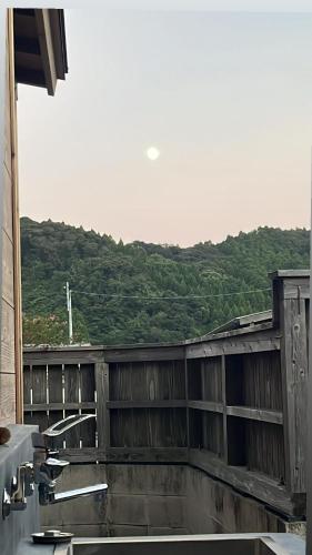 a view of a building with a mountain in the background at 青島オーベルジュ in Miyazaki