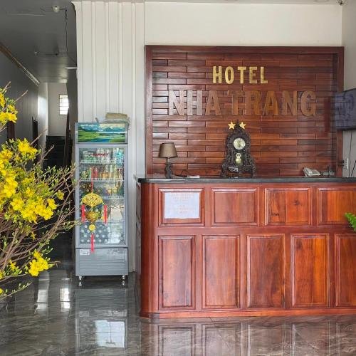 a hotel entrance with a clock and a refrigerator at Nha Trang Homestay Đồng Nai in Tân Phú