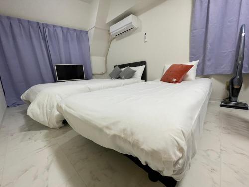 Ένα ή περισσότερα κρεβάτια σε δωμάτιο στο A&C STAY Shin-Osaka