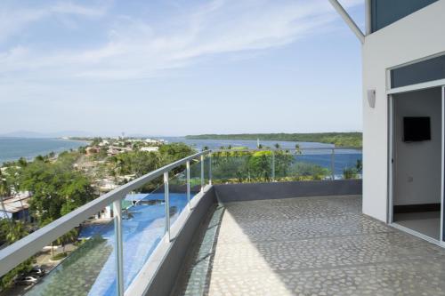 a balcony with a view of the water at Puerto Azul Hotel in Puntarenas