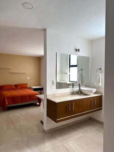 a bathroom with a sink and a bed at Casa Romelia in Acatepec