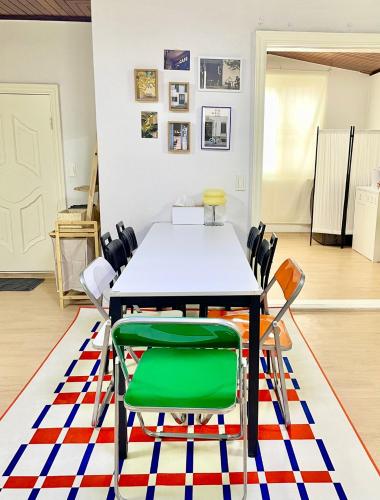 a dining room with a table and chairs on a rug at Slow Stay, #SK Hynix#5 minutes to Chungnam National University#10 minutes to Terminal#Hotel Bedding in Cheongju