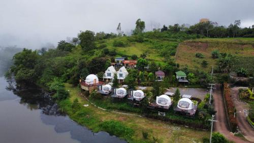 an aerial view of a house on a hill next to a river at River Hill Khaokho in Khao Kho