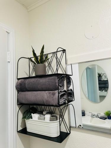 a rack with towels and a mirror in a bathroom at Contemporary Studio Near Mojave Aerospace Airport in Mojave