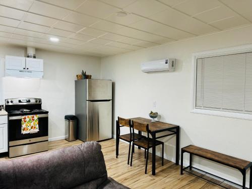 a kitchen with a couch and a table and a refrigerator at Contemporary Studio Near Mojave Aerospace Airport in Mojave