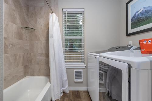 a bathroom with a sink and a bath tub and a toilet at S'more Shack in Packwood