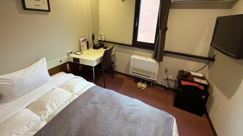 Ένα ή περισσότερα κρεβάτια σε δωμάτιο στο Hotel Sato