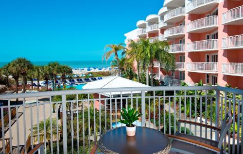 a balcony with a table and a view of the beach at Beach House Suites by the Don CeSar in St Pete Beach