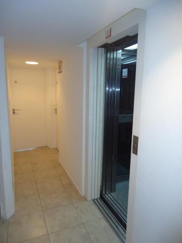 a hallway with a glass door in a building at Departamento Calle 46 in La Plata