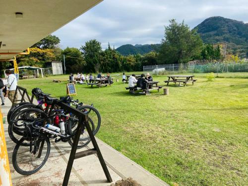 a bunch of bikes parked on a stand in a park at Heguri Hub in Minamiboso
