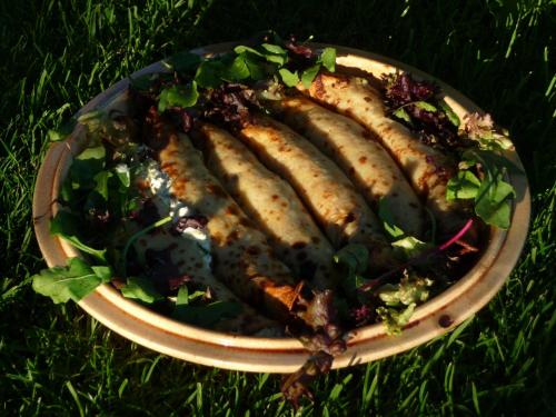 a plate of fish with a salad in the grass at Selatuinen in Appelscha