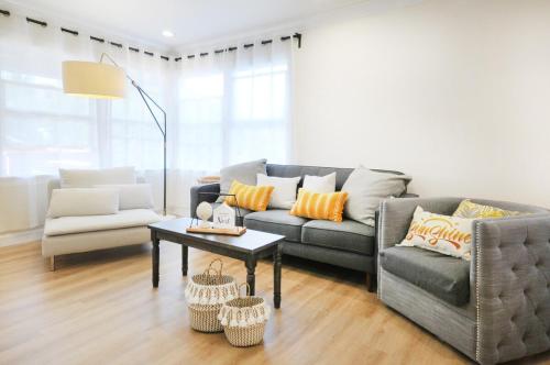 a living room with a couch and a table at Centrally Located Charming LA Home with Food Scenes in Monterey Park