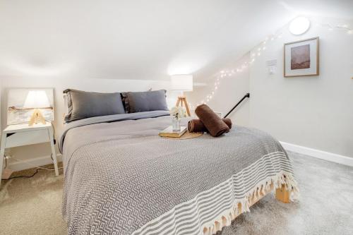 a bedroom with a bed with a night stand on it at Centrally Located Charming LA Home with Food Scenes in Monterey Park