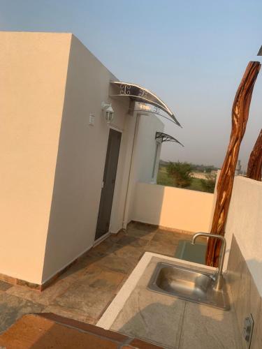 a sink in the middle of a room with a window at Sweet and Family home!! in Xochitepec