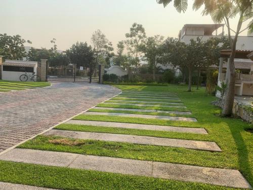 a walkway in a park with grass at Sweet and Family home!! in Xochitepec