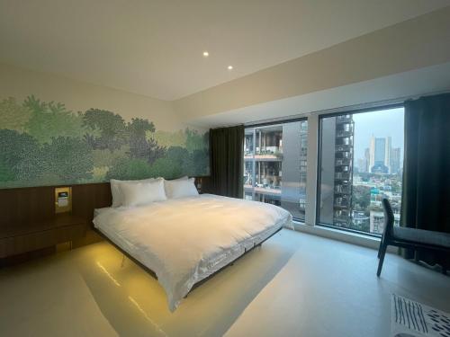 a bedroom with a bed and a large window at Lucky Jili in Chengdu