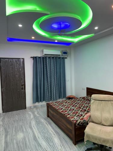 a room with a bed and a green ceiling at Shivalay residency in Jhūsi