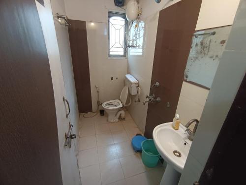 a small bathroom with a toilet and a sink at Hotel Viraat Inn in Gaya