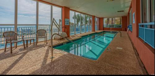 a swimming pool in a building with a view of the ocean at Oceanfront Ocean Pearl in Myrtle Beach in Myrtle Beach