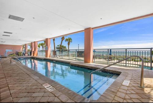 a swimming pool with a view of the ocean at Oceanfront Ocean Pearl in Myrtle Beach in Myrtle Beach
